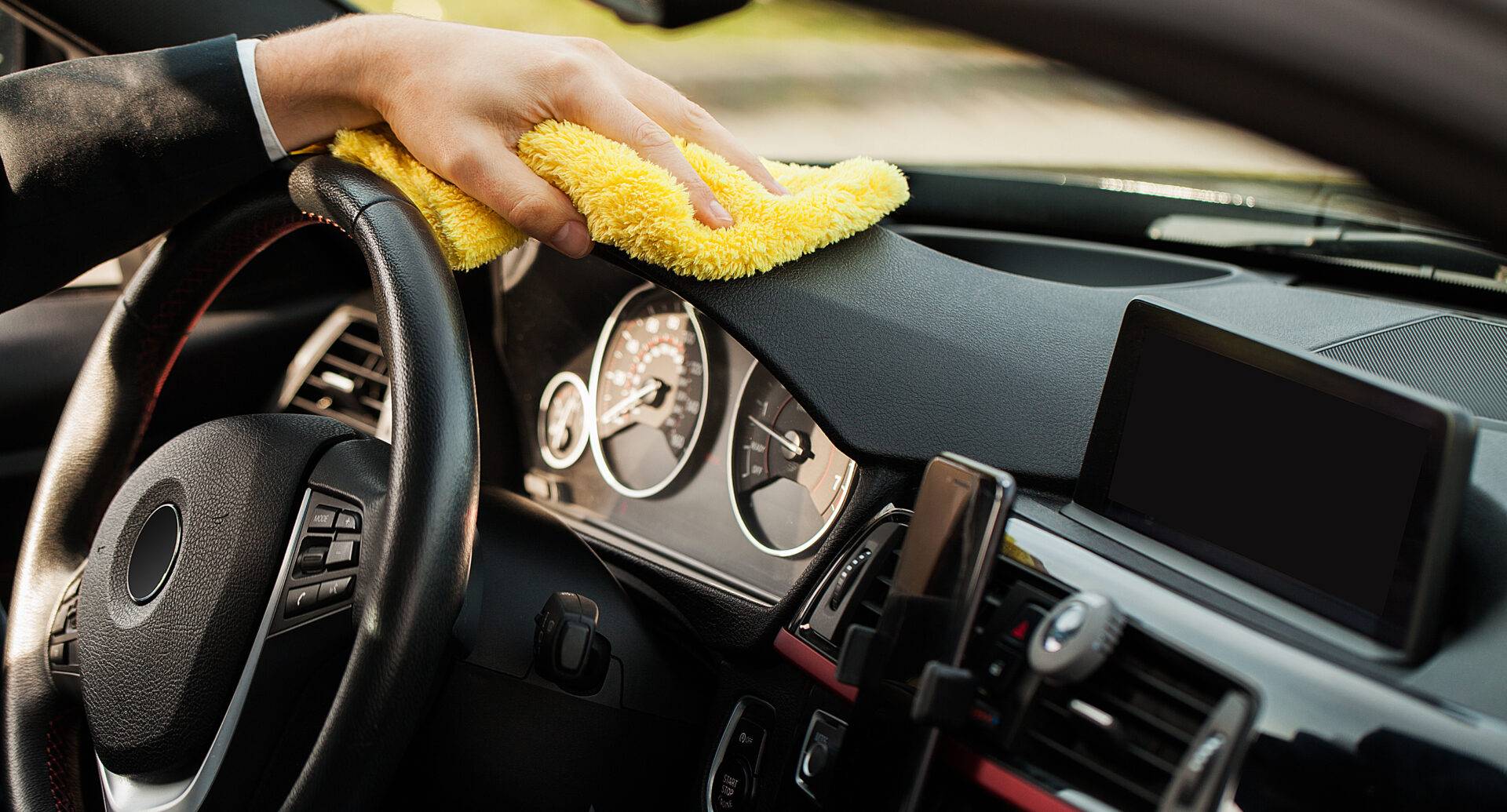 Cleaning car. Hand with microfiber cloth cleaning car interior